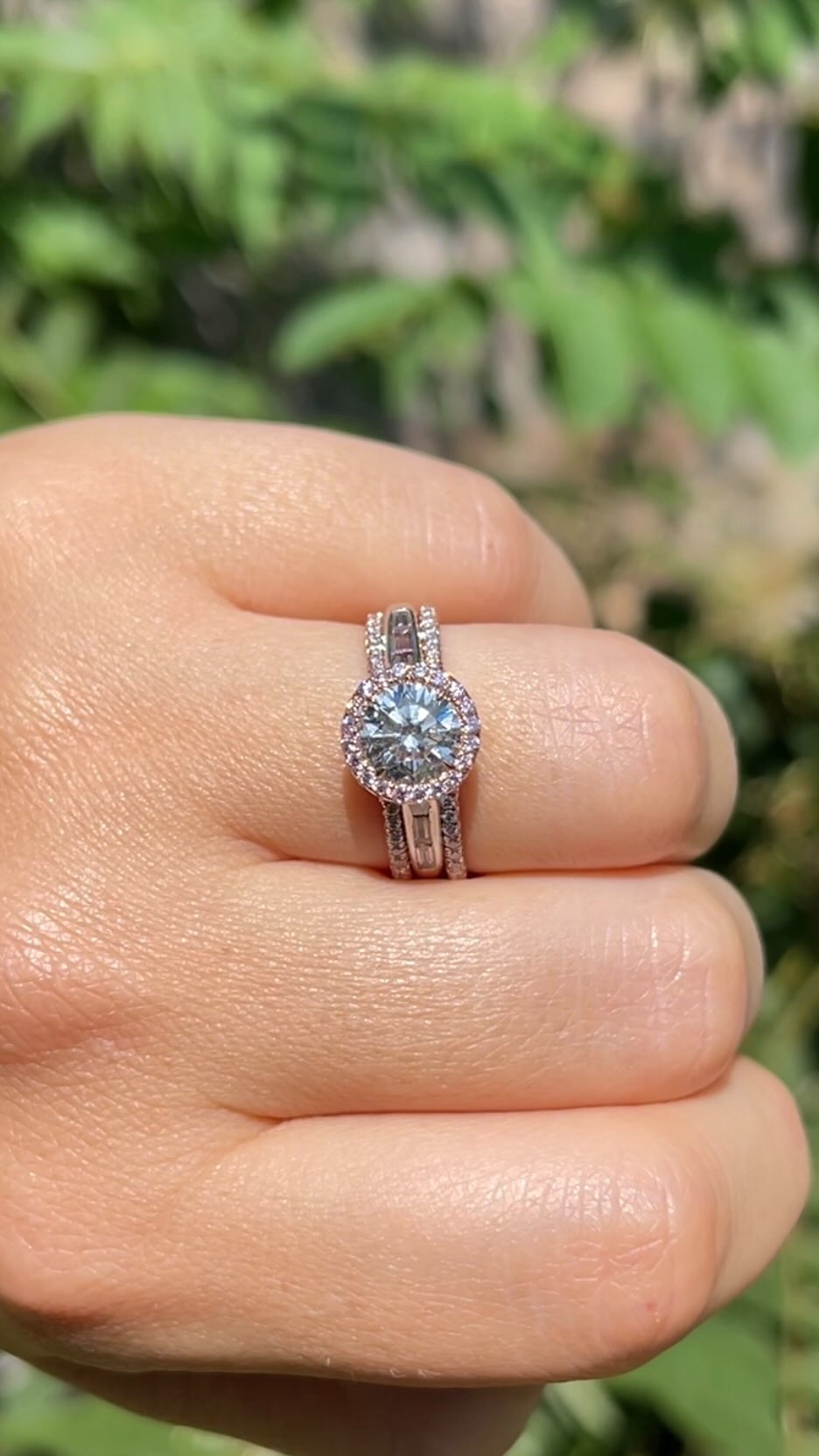 Custom halo diamond engagement ring worn on hand - Green Jewelers