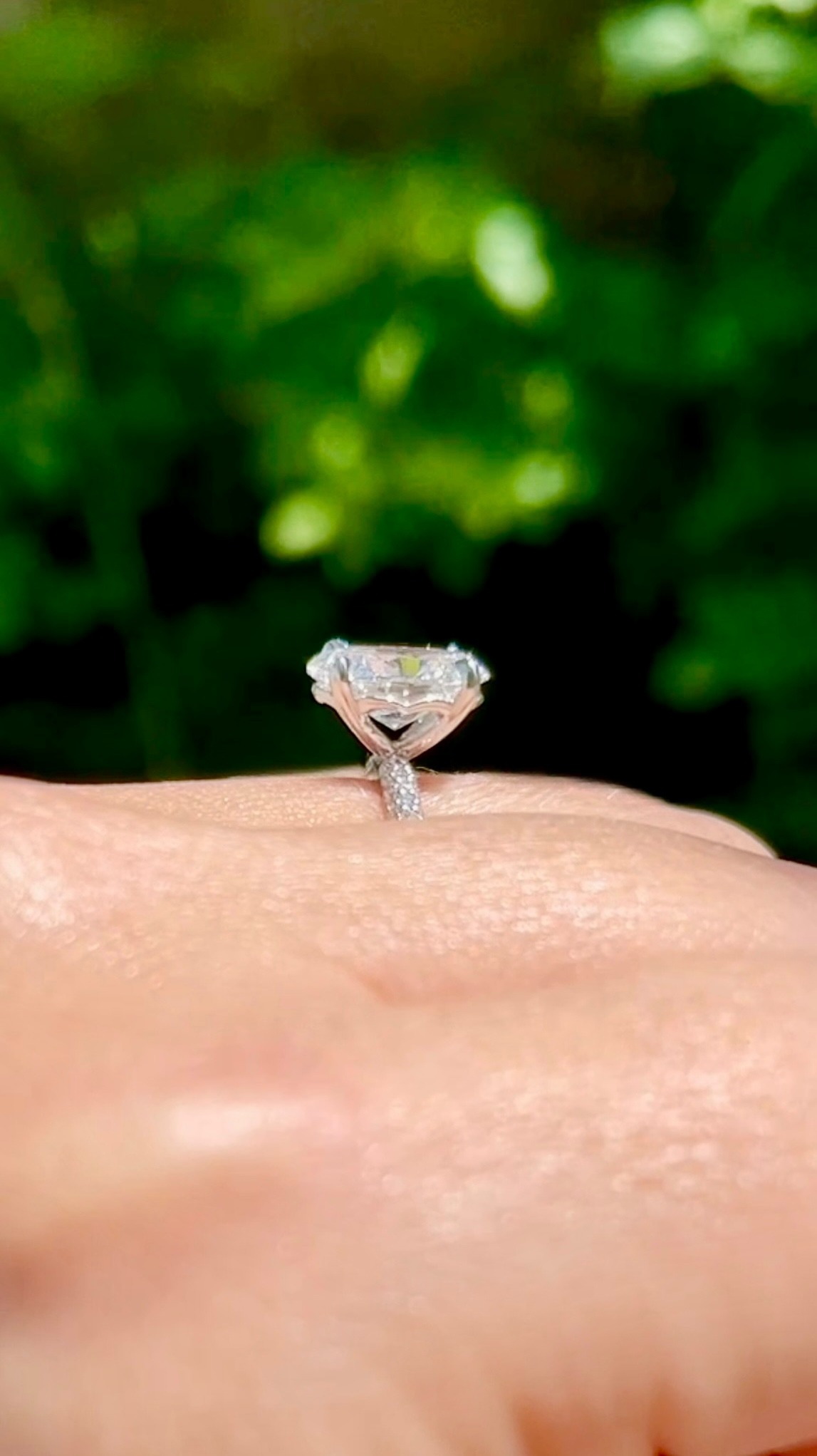 Solitaire diamond engagement ring photographed outdoors in natural light